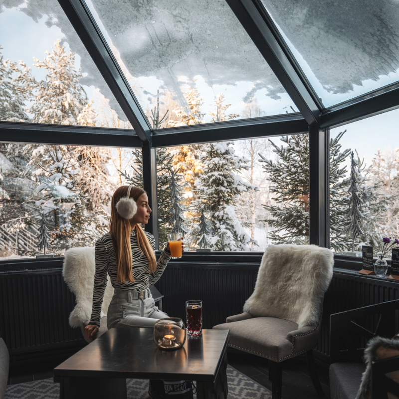 A guest enjoying a beverage in Santa's Igloos Arctic Circle lobby bar. Photo by Lost in Two.