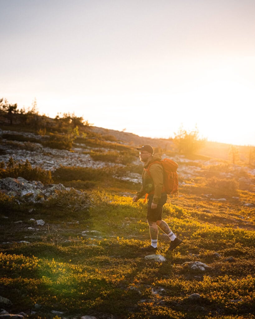 A man hiking on the fells with sunshine