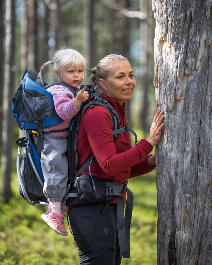 Mother and young daughter hiking in nature in summer