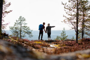A couple standing in autumn nature admiring the views