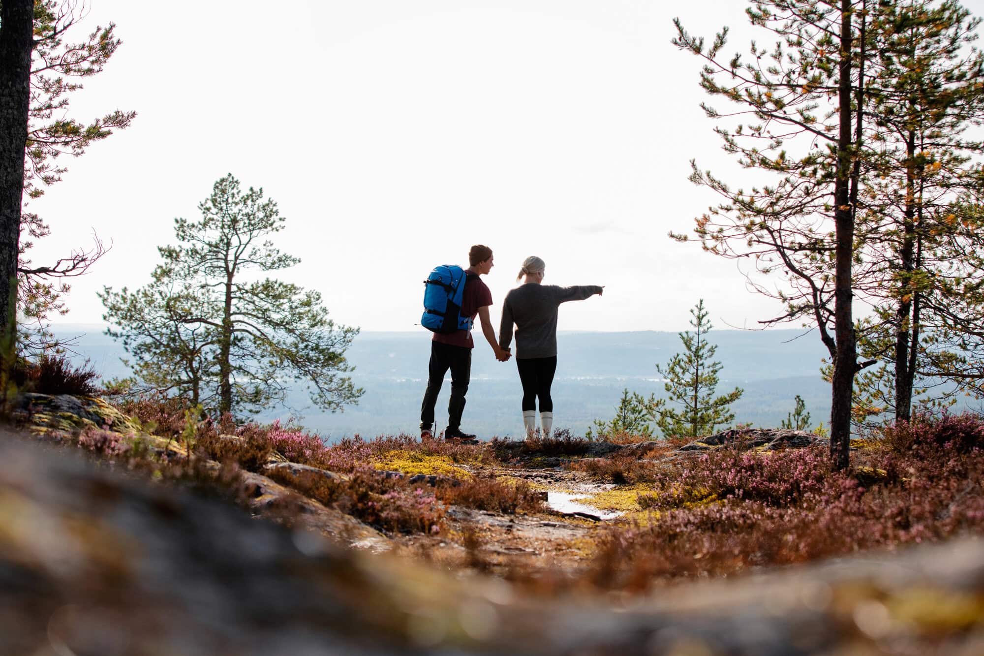 A couple standing in autumn nature admiring the views
