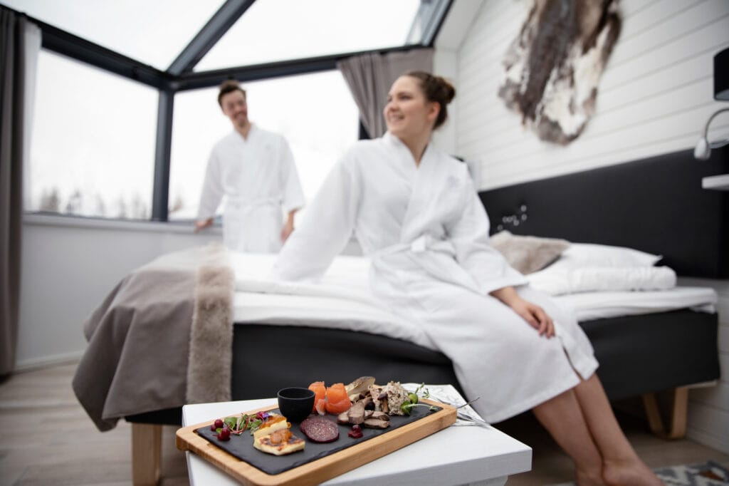 Couple and a savoury platter in a glass igloo
