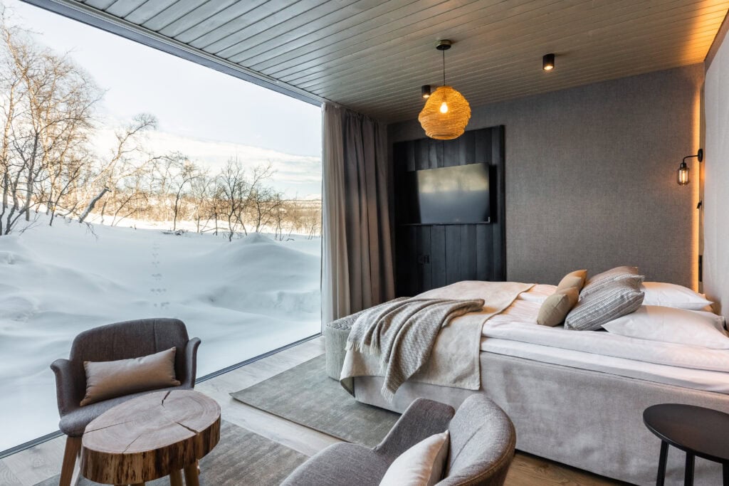 Hotel room with winter views and hare tracks on the snow visible from the window