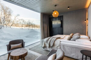 Hotel room with winter views and hare tracks on the snow visible from the window