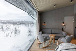 Hotel room seating area and winter landscape in the window