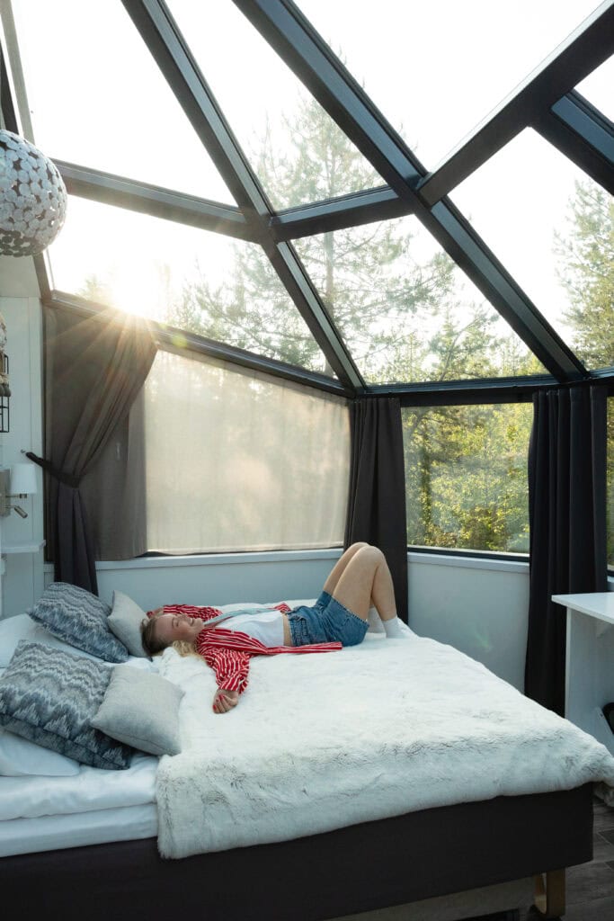Woman laying in bed in an igloo at summer